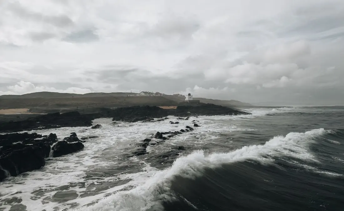 Waves along the rocky coast at Bamburgh in Northumberland